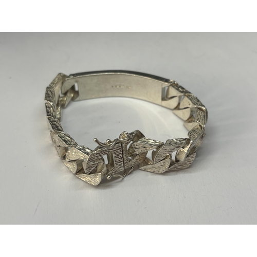 557 - A HEAVY HALLMARKED LONDON SILVER BARK DESIGN ID BRACELET