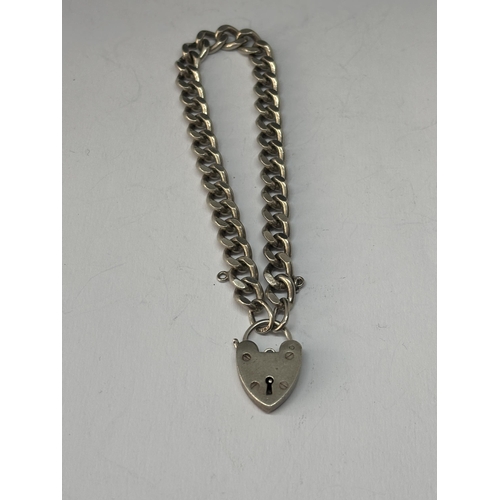 564 - A SILVER WRIST CHAIN WITH HEART PADLOCK FASTEN