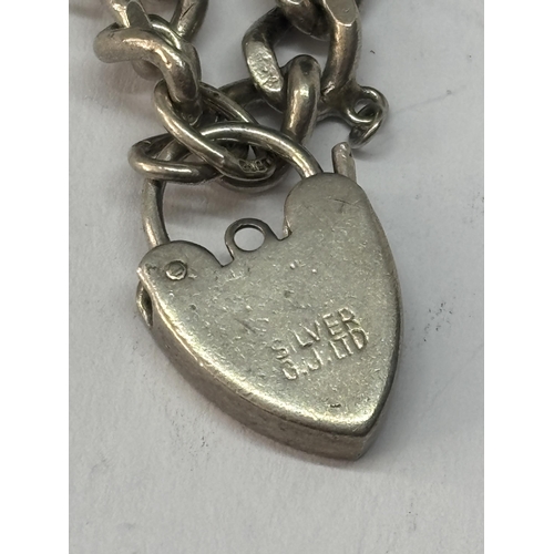 564 - A SILVER WRIST CHAIN WITH HEART PADLOCK FASTEN