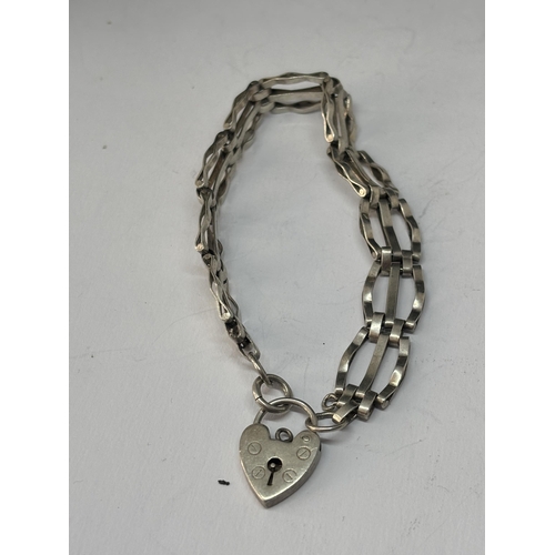 565 - A MARKED SILVER GATE BRACELET WITH HEART PADLOCK AND A SILVER PENDANT