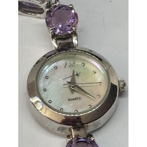 568 - A SILVER AND AMETHSYT WRISTWATCH SEEN WORKING BUT NO WARRANTY GIVEN