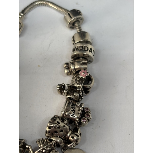 572 - A MARKED SILVER PANDORA STYLE BRACELET WITH SEVENTEEN CHARMS