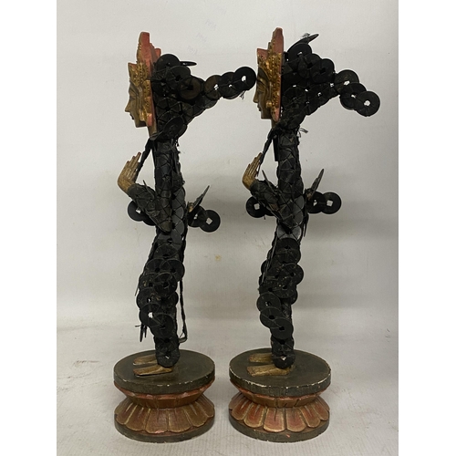 322 - A PAIR OF BALINESE TRIBAL FIGURES ON WOODEN LOTUS THRONES THEIR BODIES CONSTRUCTED FROM CHINESE COIN... 