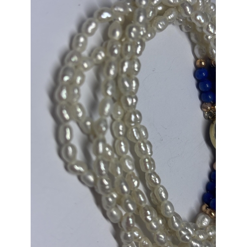 595 - A SEED PEARL BRACELET WITH A SILVER GILT CLASP