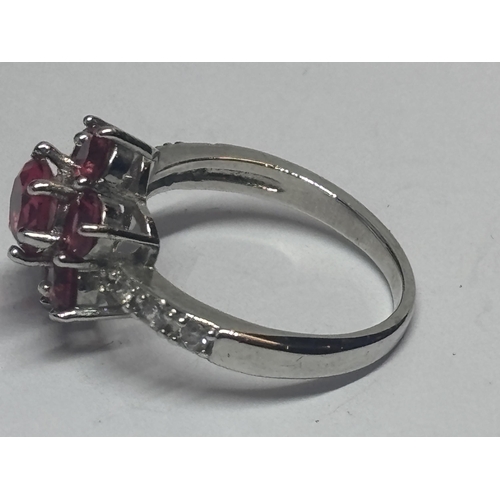 601 - A SILVER AND PINK STONE CLUSTER DRESS RING IN A PRESENTATION BOX