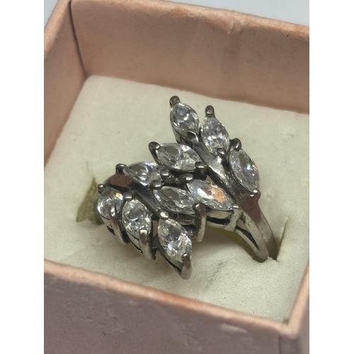 606 - A SILVER DRESS RING WITH CLEAR STONE PETAL DESIGN SIZE R/S IN A PRESENTATION BOX