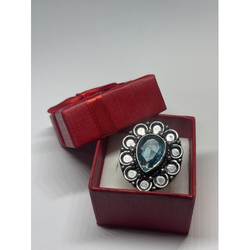 614 - A MARKED 925 SILVER AND BLUE TEARDROP  STONE RING SIZE N/O IN A PRESENTATION BOX