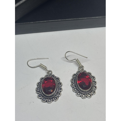 627 - A PAIR OF MARKED 925 SILVER EARRINGS WITH RED STONES IN A PRESENTATION BOX