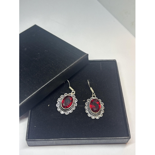 627 - A PAIR OF MARKED 925 SILVER EARRINGS WITH RED STONES IN A PRESENTATION BOX