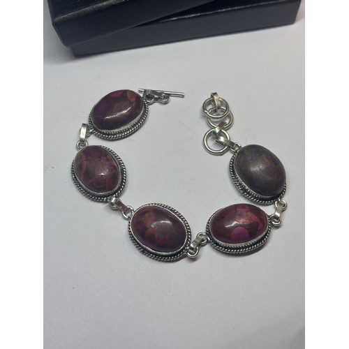 631 - A MARKED 925 SILVER BRACELET WITH PURPLE AND RED STONES IN A PRESENTATION BOX