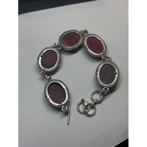 631 - A MARKED 925 SILVER BRACELET WITH PURPLE AND RED STONES IN A PRESENTATION BOX