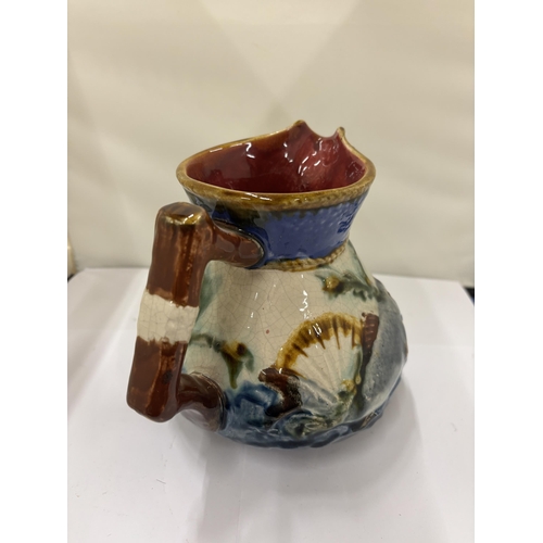 11 - A LATE 19TH CENTURY, SHORTER, MAJOLICA POTTERY JUG WITH FISH AND SEAWEED DECORATION, HEIGHT 15CM