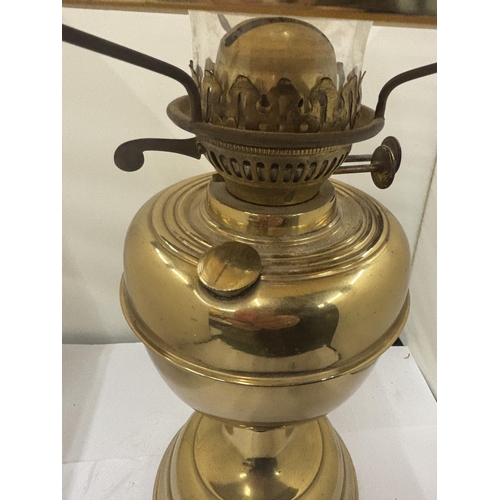 110 - A VINTAGE BRASS OIL LAMP WITH MUSTARD GLASS SHADE AND FUNNEL, HEIGHT 52CM