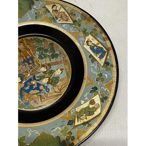 328 - A LACQUERED PAPIER MACHE FOOTED PLATE WITH VINE LEAF SHAPED HANDLES IN THE JAPANESE AESTHETIC STYLE ... 