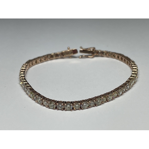 511 - A MARKED 14K ROSE TENNIS BRACELET WITH A GEMOLOGY CARD IN A PRESENTATION BOX