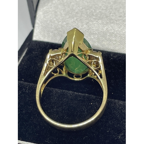 640 - A MARKED 14 CARAT GOLD RING WITH LARGE TEARDROP SHAPED EMERALD WITH DIAMONDS TO EACH SIDE SIZE N/O I... 