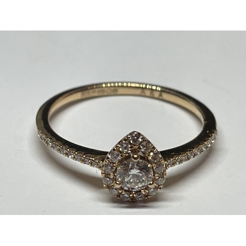 642 - A MARKED 18 CARAT GOLD RING WITH DIAMONDS TO INCLUDE A CENTRE SURROUNDED BY SMALLER IN A HEART SHAPE... 