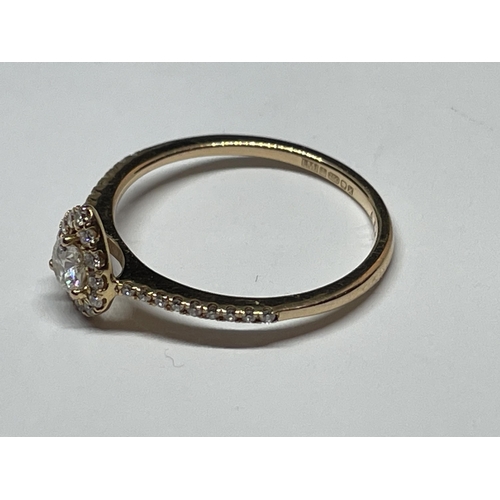 642 - A MARKED 18 CARAT GOLD RING WITH DIAMONDS TO INCLUDE A CENTRE SURROUNDED BY SMALLER IN A HEART SHAPE... 