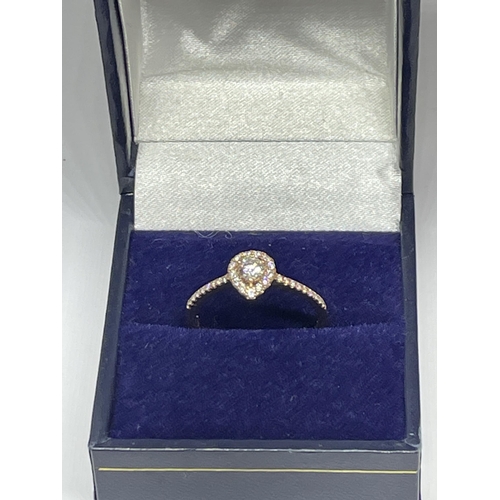 642 - A MARKED 18 CARAT GOLD RING WITH DIAMONDS TO INCLUDE A CENTRE SURROUNDED BY SMALLER IN A HEART SHAPE... 