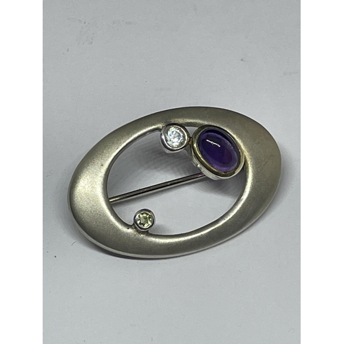 648 - A MARKED 925 SILVER MACKINTOSH BROOCH WITH PURPLE, GREEN AND CLEAR STONE