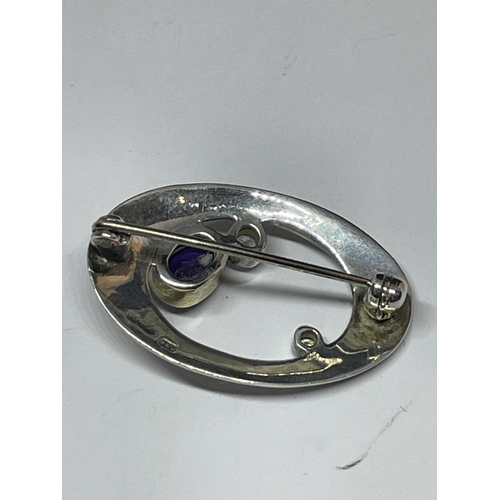 648 - A MARKED 925 SILVER MACKINTOSH BROOCH WITH PURPLE, GREEN AND CLEAR STONE