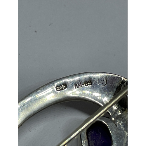 648 - A MARKED 925 SILVER MACKINTOSH BROOCH WITH PURPLE, GREEN AND CLEAR STONE