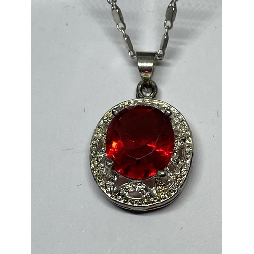 652 - A MARKED SILVER NECKLACE WITH RED STONE PENDANT IN A PRESENTATION BOX