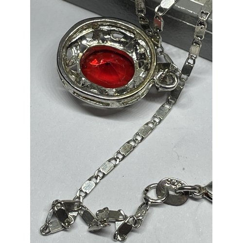 652 - A MARKED SILVER NECKLACE WITH RED STONE PENDANT IN A PRESENTATION BOX