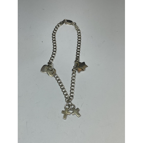 662 - A MARKED SILVER BRACELET WITH DOUBLE HEART, DOUBLE CROSS AND DOUBLE STAR CHARMS