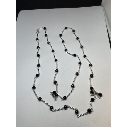 664 - A MARKED SILVER NECKLACE WITH BLACK ONYX BEADS