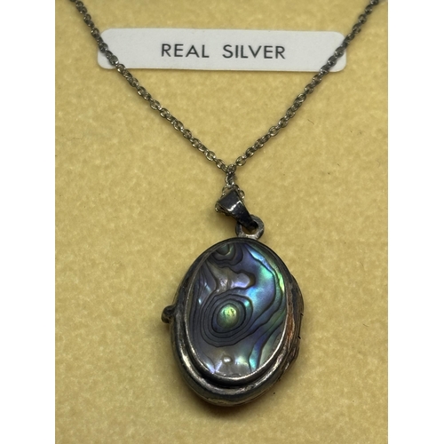 671 - FOUR MARKED SILVER ITEMS TO INCLUDE A NECKLACE WITH PAUA SHELL LOCKET, A BOX LINK NECKLACE, CROSS PE... 