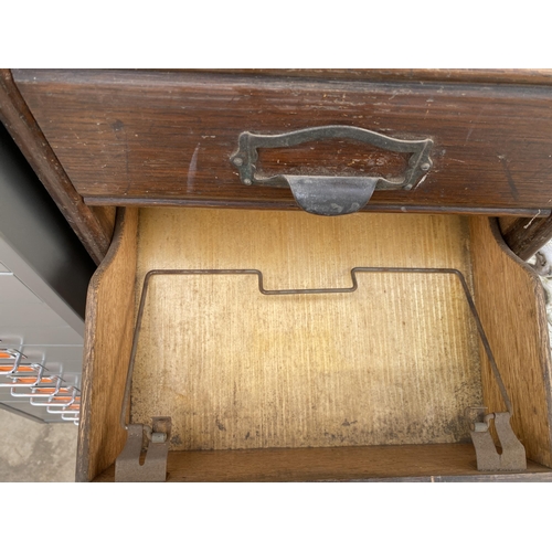 1503 - A VINTAGE TEN DRAWER OAK FILING CHEST WITH SCOOP HANDLES