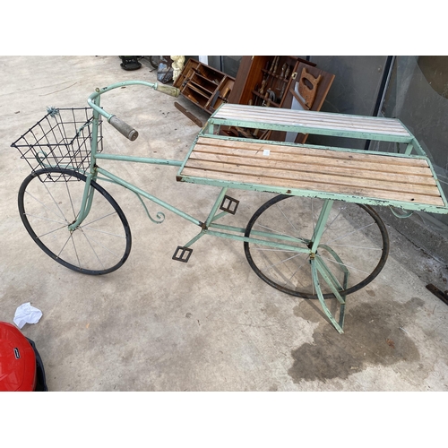 1506 - A VINTAGE STYLKE METAL SHOP DISPLAY BIKE WITH FOLDING BENCH SIDES AND A STORAGE SECTION