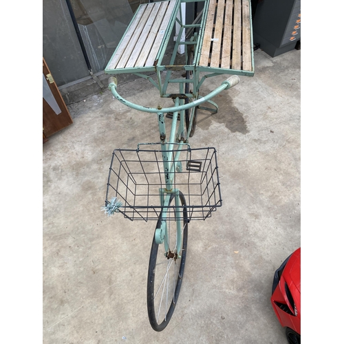 1506 - A VINTAGE STYLKE METAL SHOP DISPLAY BIKE WITH FOLDING BENCH SIDES AND A STORAGE SECTION