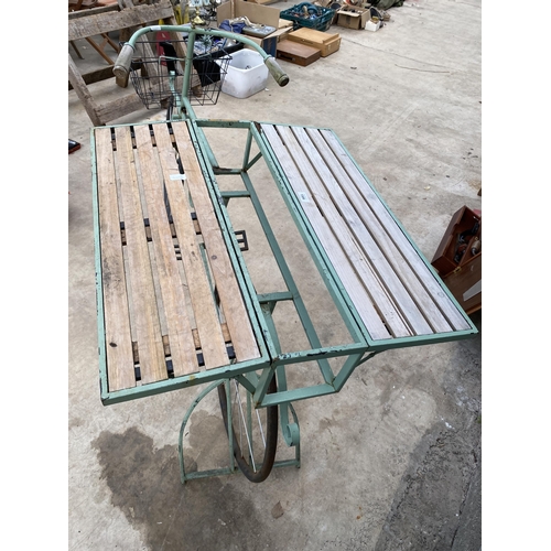 1506 - A VINTAGE STYLKE METAL SHOP DISPLAY BIKE WITH FOLDING BENCH SIDES AND A STORAGE SECTION