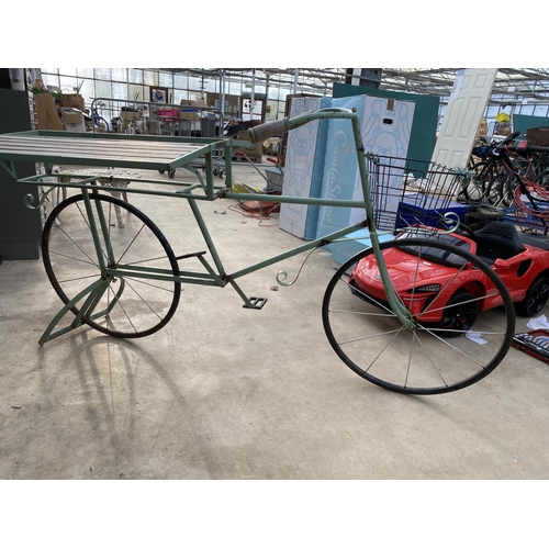 1506 - A VINTAGE STYLKE METAL SHOP DISPLAY BIKE WITH FOLDING BENCH SIDES AND A STORAGE SECTION