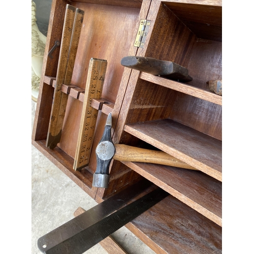 1509 - A TEAK JOINERS CHEST WITH AN ASSORTMENT OF TOOLS TO INCLUDE WOOD PLANES, A HAMMER AND A SAW ETC