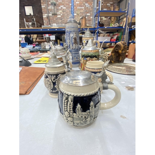 243 - A COLLECTION OF LIDDED STEINS