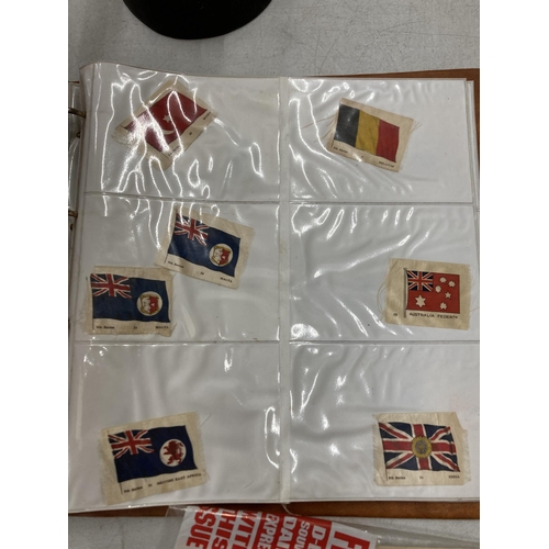 245 - A COLLECTION OF VINTAGE SILK FLAGS IN AN ALBUM