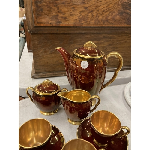 254 - A VINTAGE CARLTON WARE BURGUNDY AND GILT COFFEE SET TO INCLUDE A COFFEE POT, SUGAR BOWL, CREAM JUG, ... 