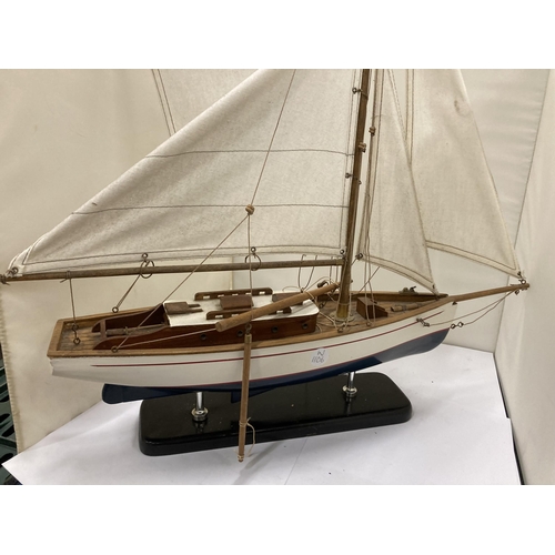 294 - A SMALL WOODEN MODEL OF A SAILING YACHT