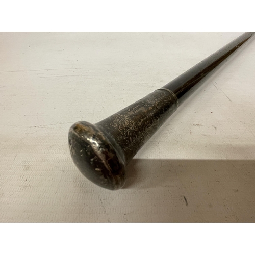 36 - A VINTAGE WALKING CANE WITH A WHITE METAL TOP