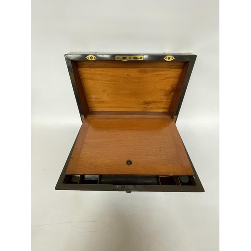 45 - A LARGE MAHOGANY WRITING SLOPE BOX WITH ONE INKWELL, BRASS BINDING AND A VACANT CARTOUCHE, HEIGHT 19... 