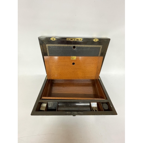 45 - A LARGE MAHOGANY WRITING SLOPE BOX WITH ONE INKWELL, BRASS BINDING AND A VACANT CARTOUCHE, HEIGHT 19... 