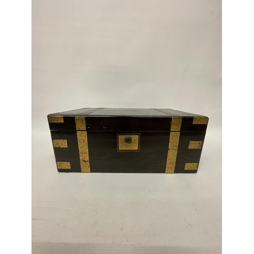 45 - A LARGE MAHOGANY WRITING SLOPE BOX WITH ONE INKWELL, BRASS BINDING AND A VACANT CARTOUCHE, HEIGHT 19... 