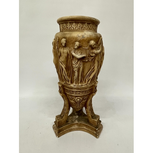 63 - A LARGE STONEWARE VASE WITH RELIEF CLASSICAL DECORATION ON A TRIPOD STYLE BASE, HEIGHT 43CM