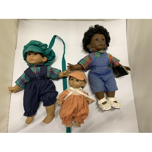 425 - THREE BOXED DOLLS WITH CLOTHING