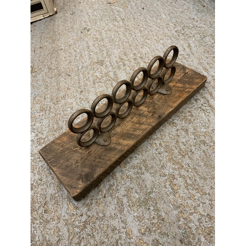 461 - A WALL MOUNTED RUSTIC WOOD AND METAL EGG HOLDER