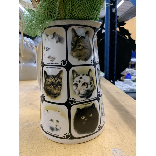 495 - A CERAMIC JUG WITH CAT PICTURES CONTAINING DRIED FLOWERS AND GRASSES