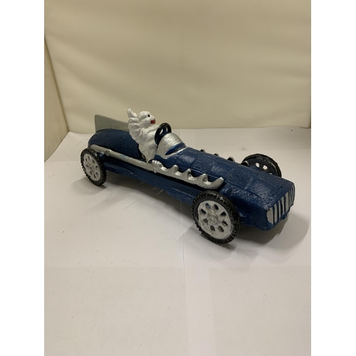 822 - A CAST MICHELIN MAN IN A BLUE RACING CAR, LENGTH 26CM